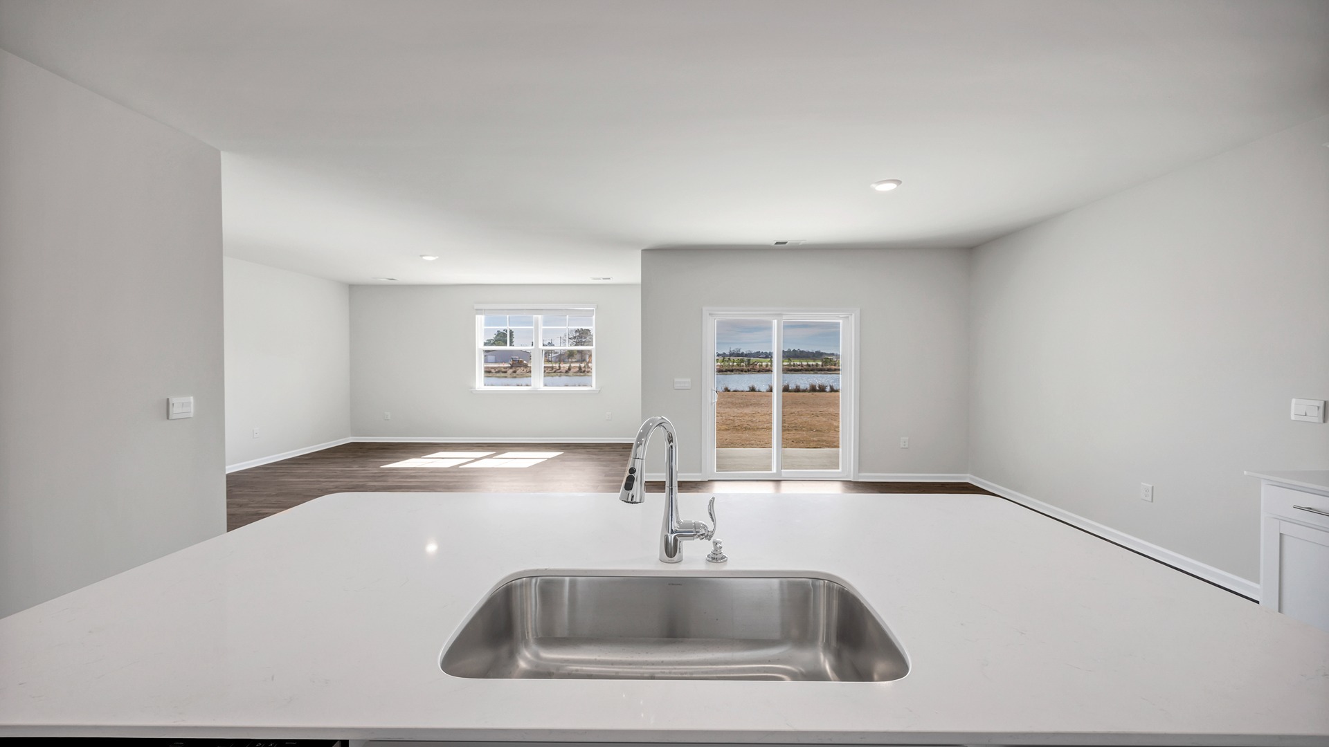Kitchen sink on the floating island overlooks dining and living spaces