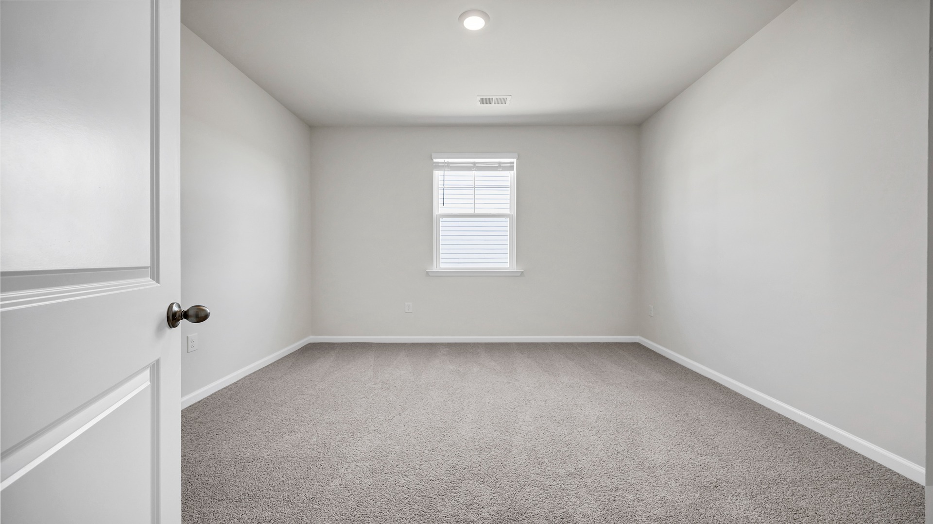 Bedroom 4 with a window for light and carpet flooring