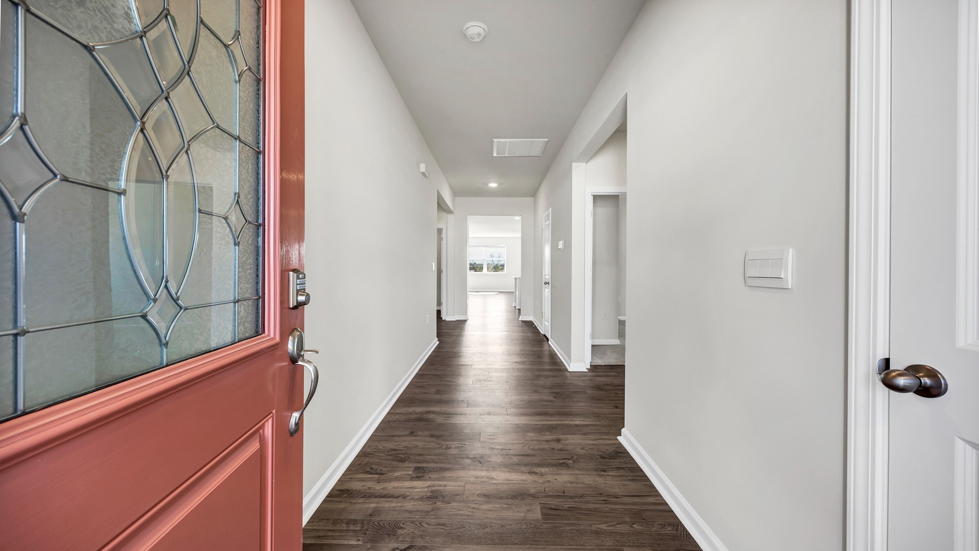 Front foyer welcomes you into the home from the coral-colored front door