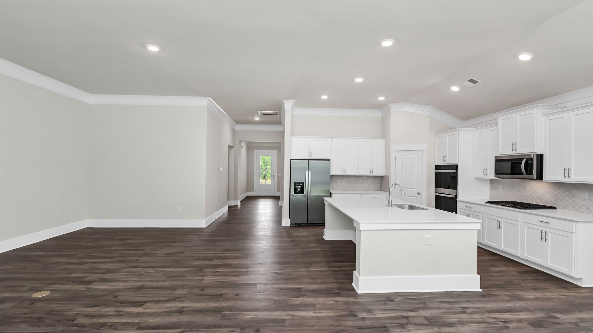 The dining, living, kitchen areas are open concept design finished with Revwood flooring.