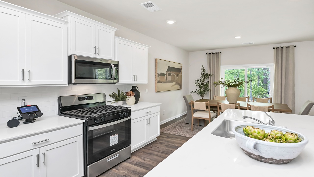 Tile backsplash and white quartz countertops in kitchen