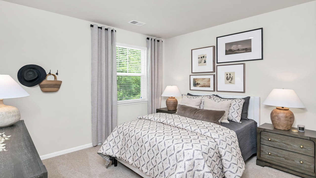 Downstairs bedroom with a window and carpet flooring