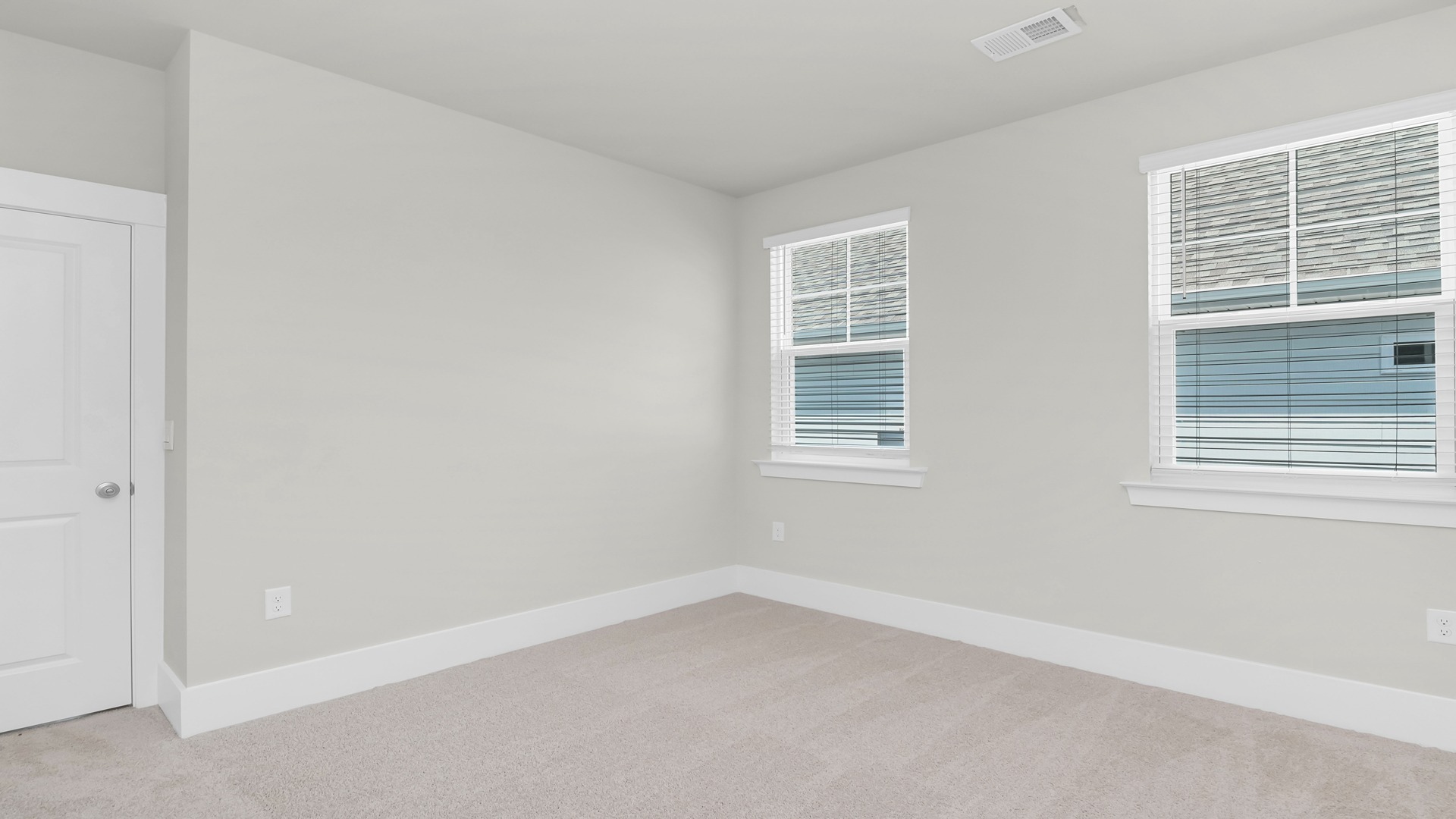 Bedroom 3 is central in the home and features carpet flooring and 2 windows,