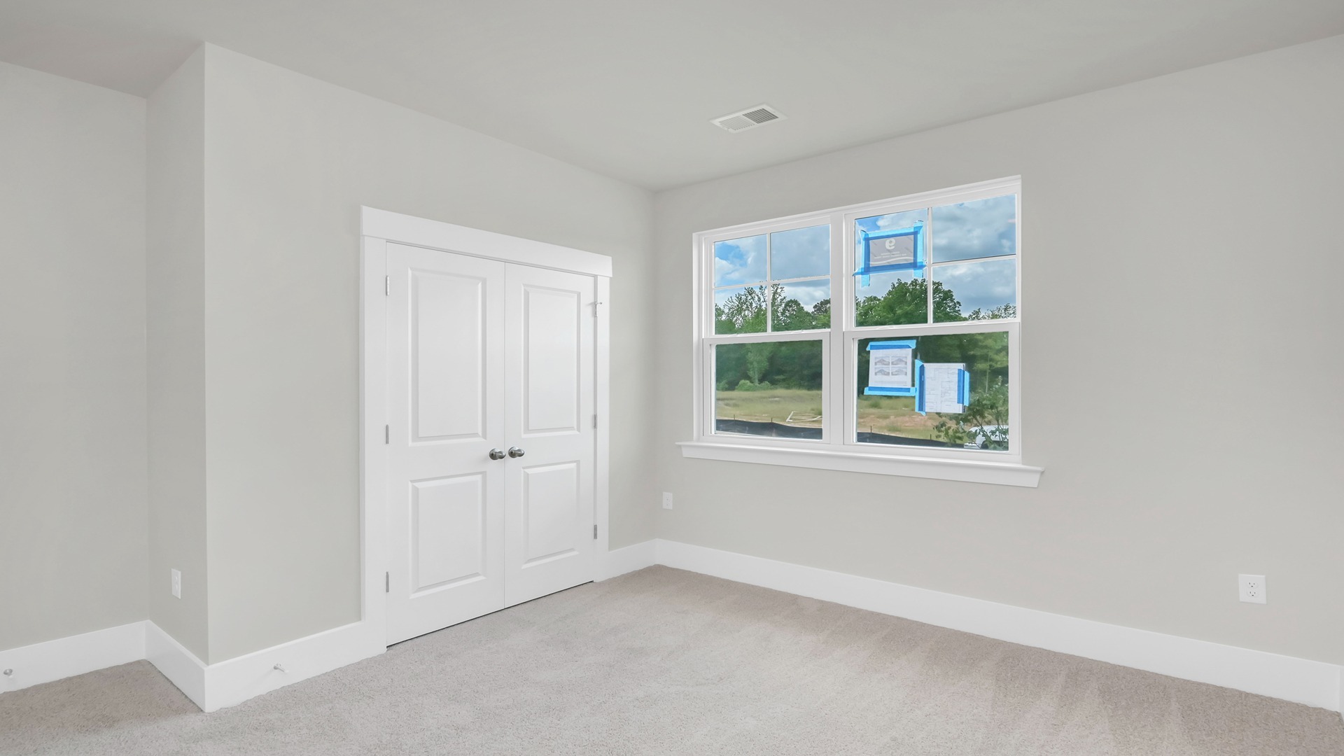Front bedroom 2 with a private closet and a front facing window