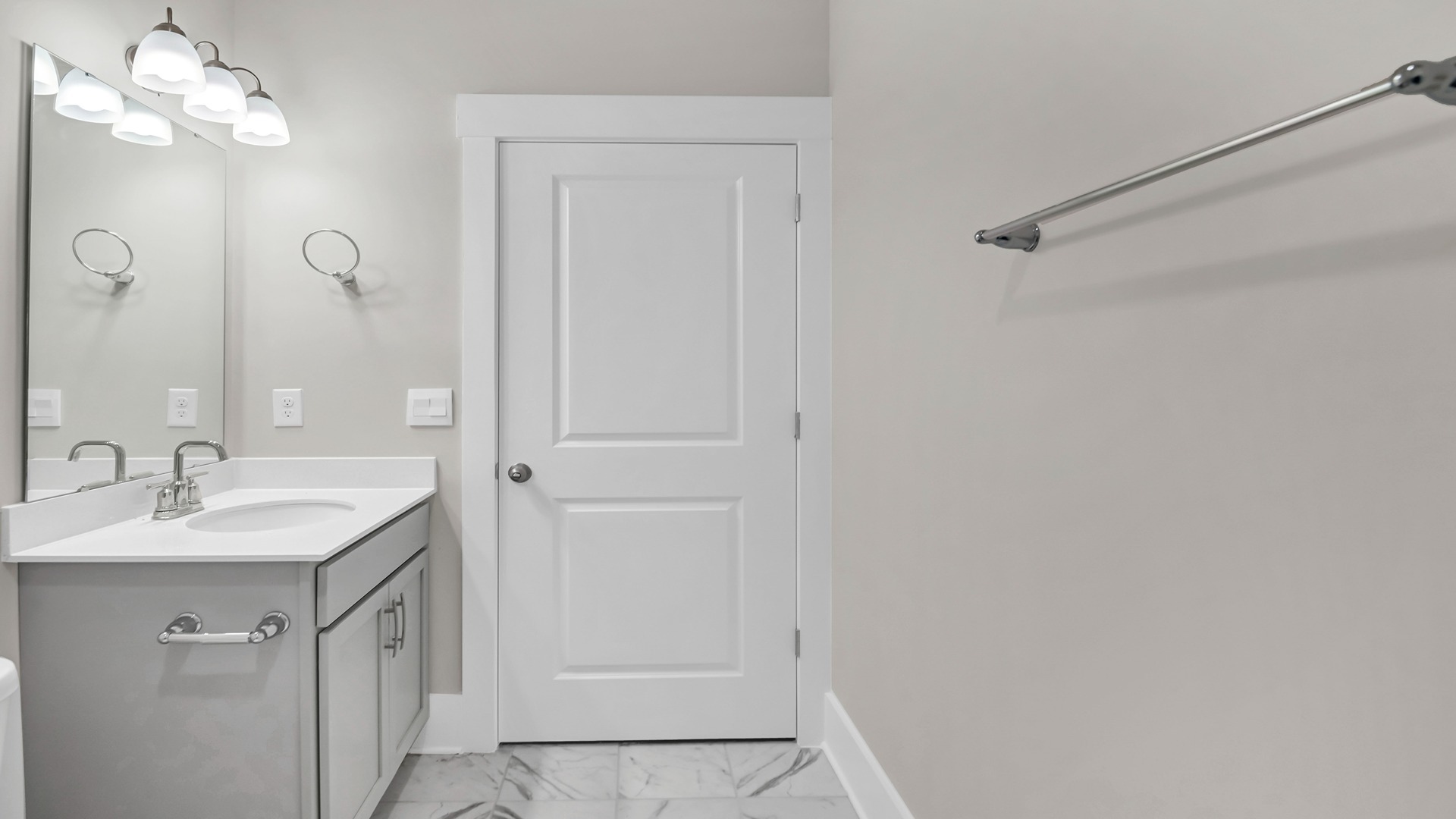 Bathroom 2 with gray cabinetry under the sink