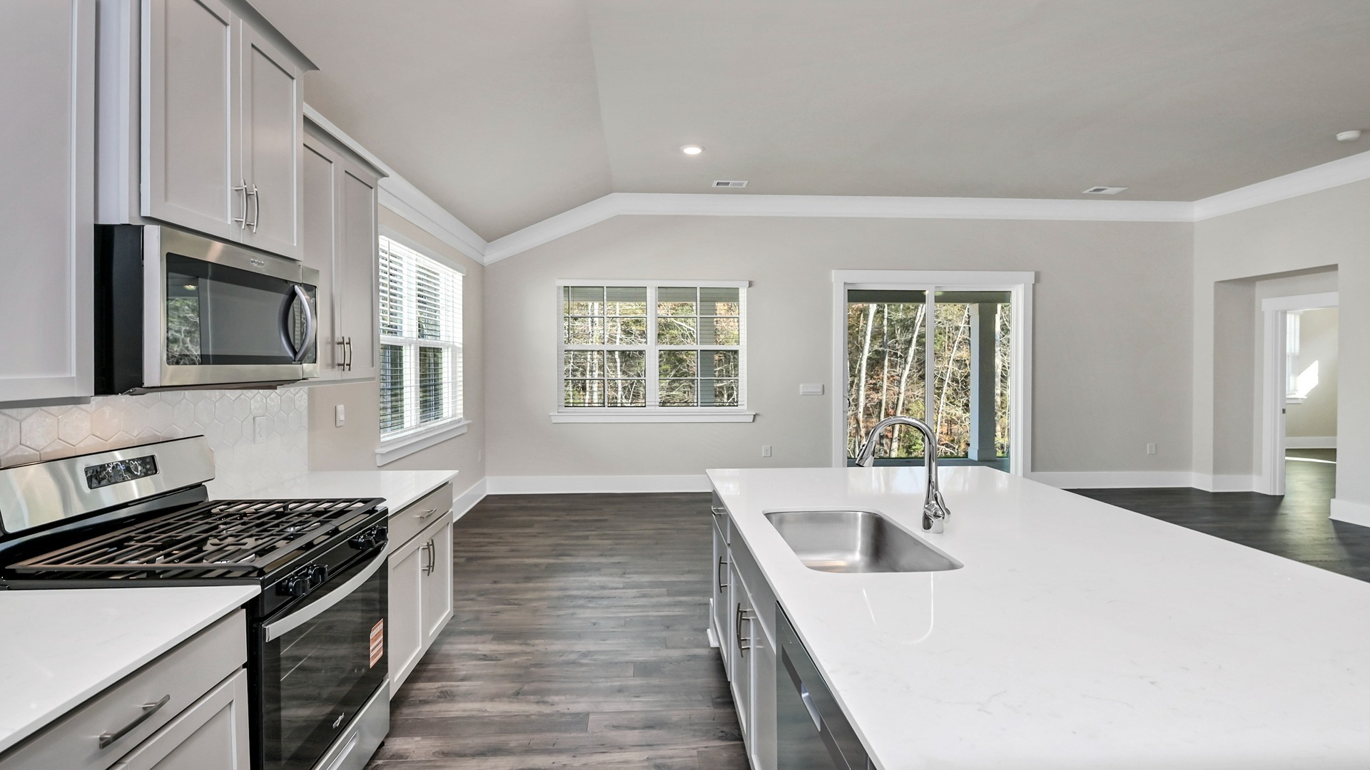 Quartz countertops and tile backsplash in kitchen