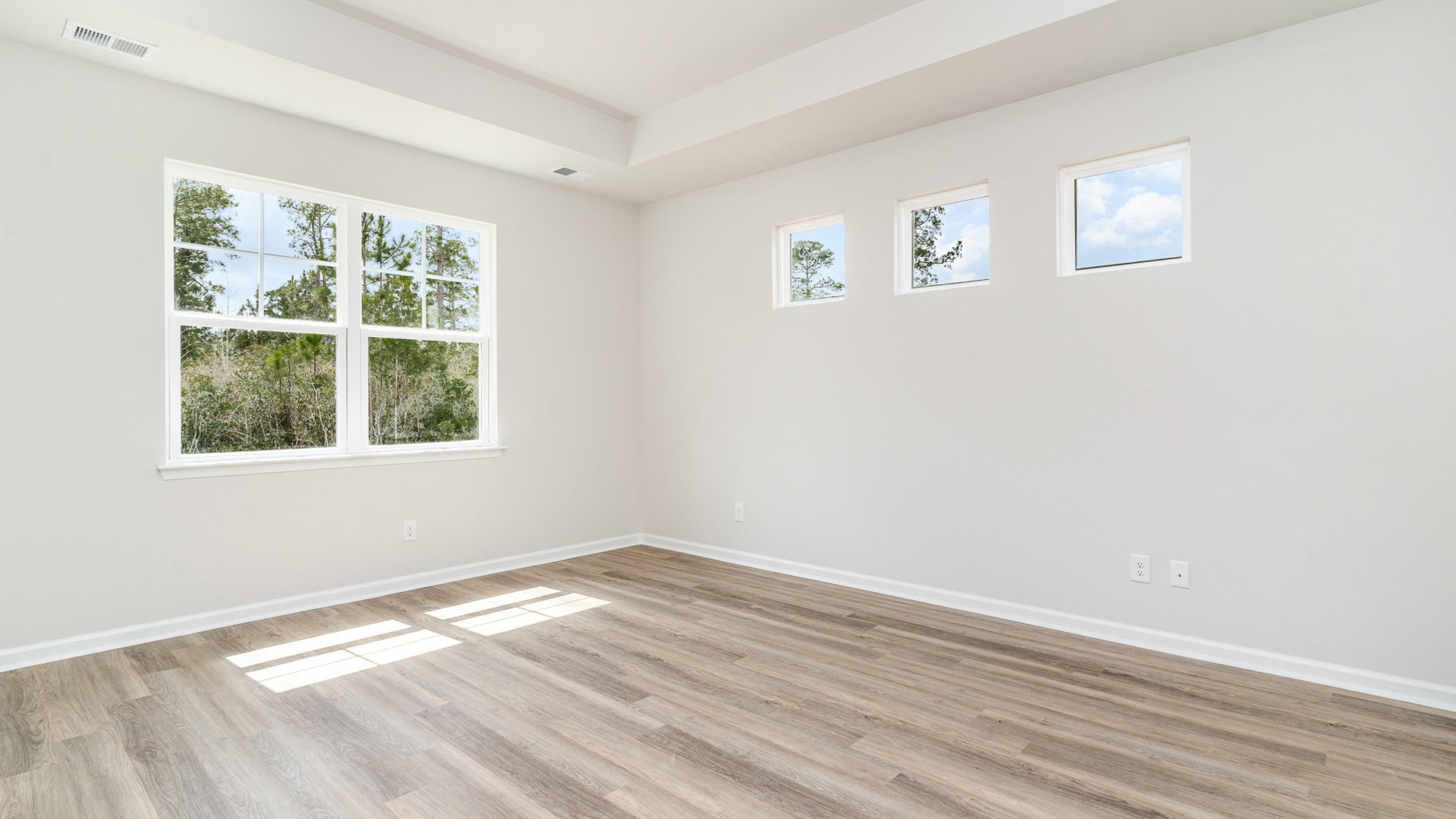 Primary bedroom with Revwood flooring