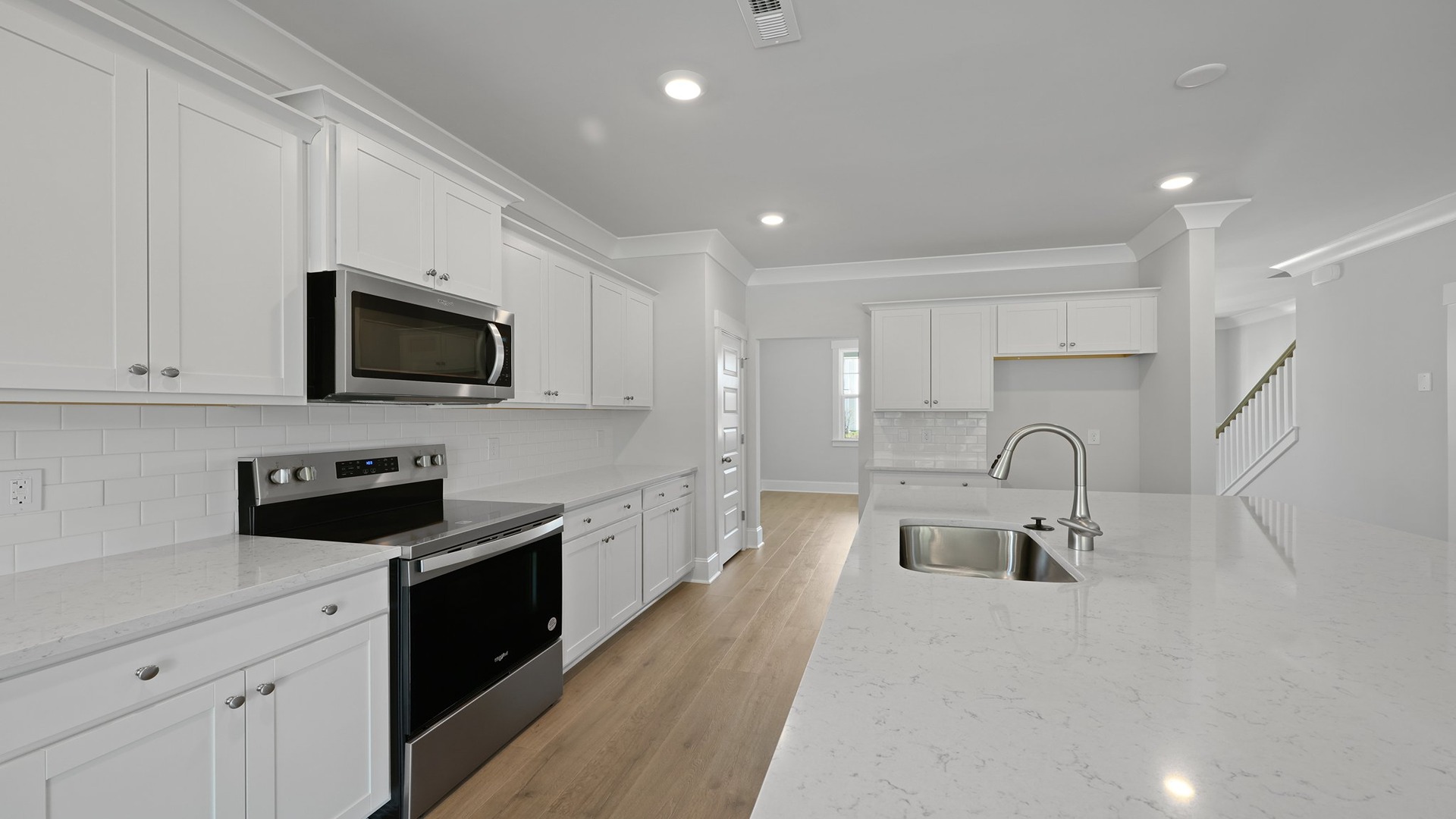 White cabinetry and white quartz countertops in the kitchen