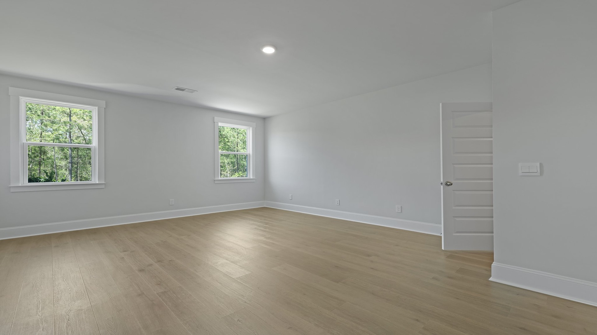 Two windows in primary bedroom for light