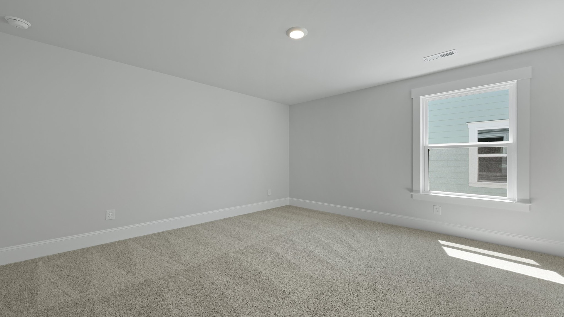 Bedroom 5 upstairs with window for light and carpet flooring