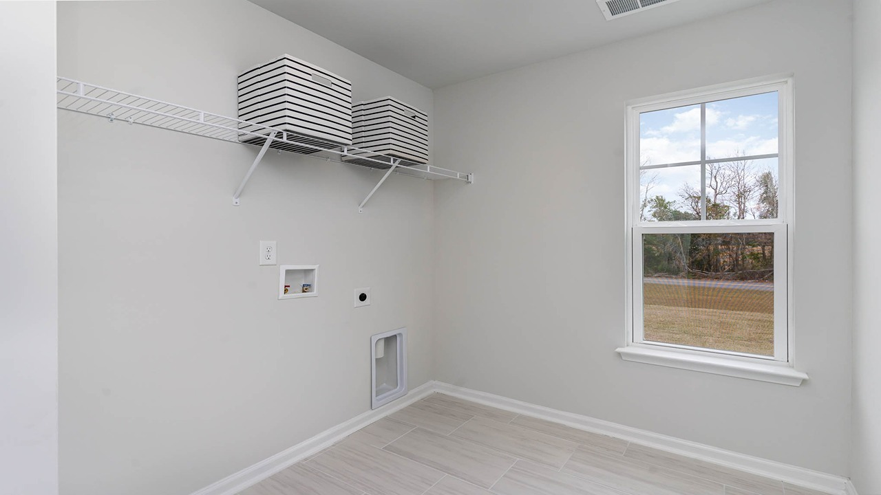 Laundry room upstairs with a window for light
