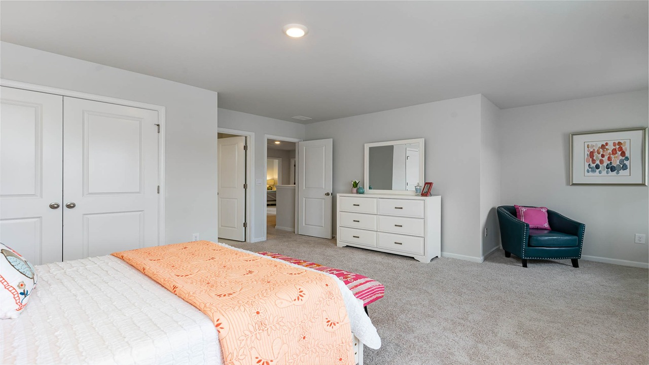 Bedroom 2 with a front facing window and a walk-in closet