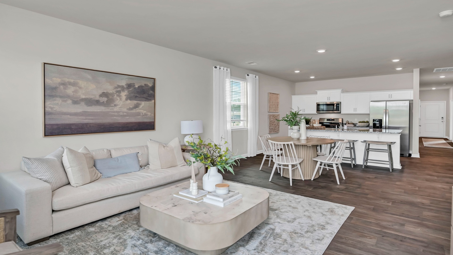 Open concept main living areas with matching vinyl floors
