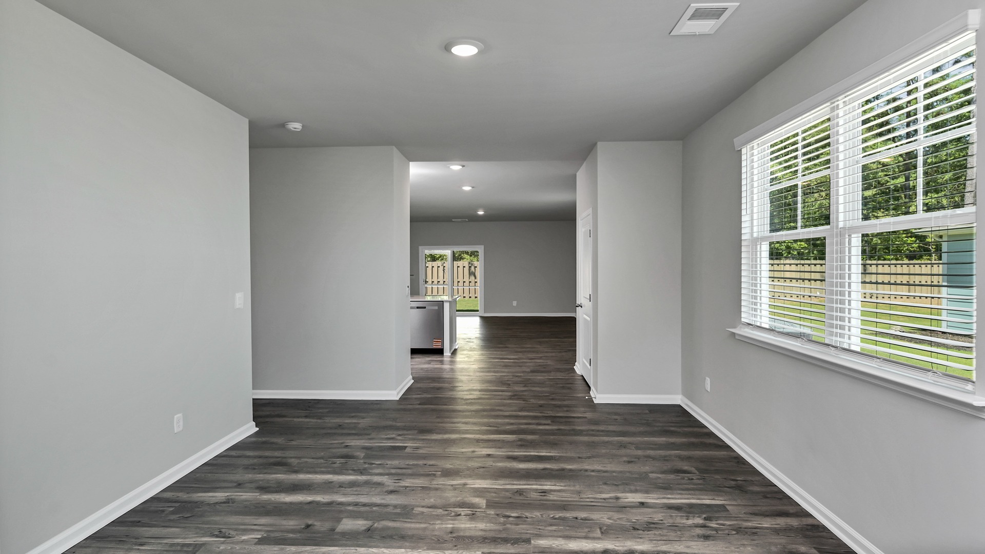 Dining area welcomes you into the home with vinyl flooring and natural light