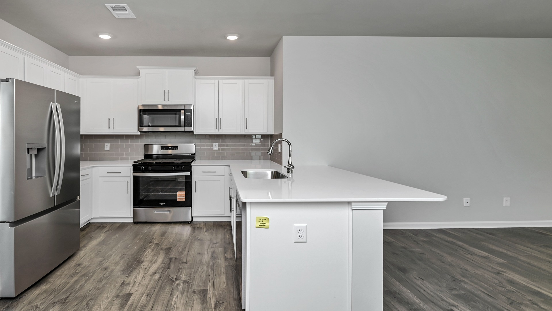 Allex kitchen with white cabinetry and white quartz countertops
