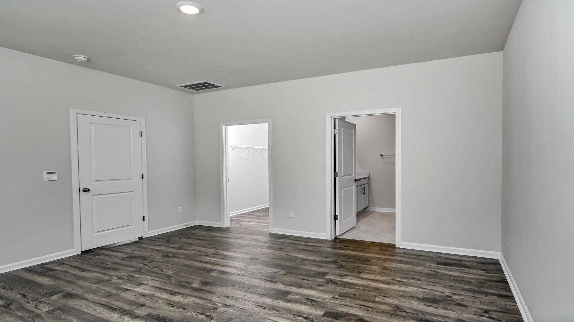 Direct access to the walk-in closet and primary bathroom