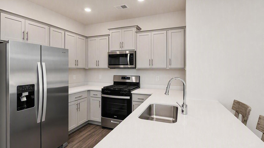 Quartz countertops and gray cabinets in new construction kitchen in Allex floor plan for sale in Orangeburg