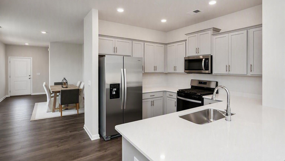 Dining area leads into the modern kitchen with stainless-steel appliances