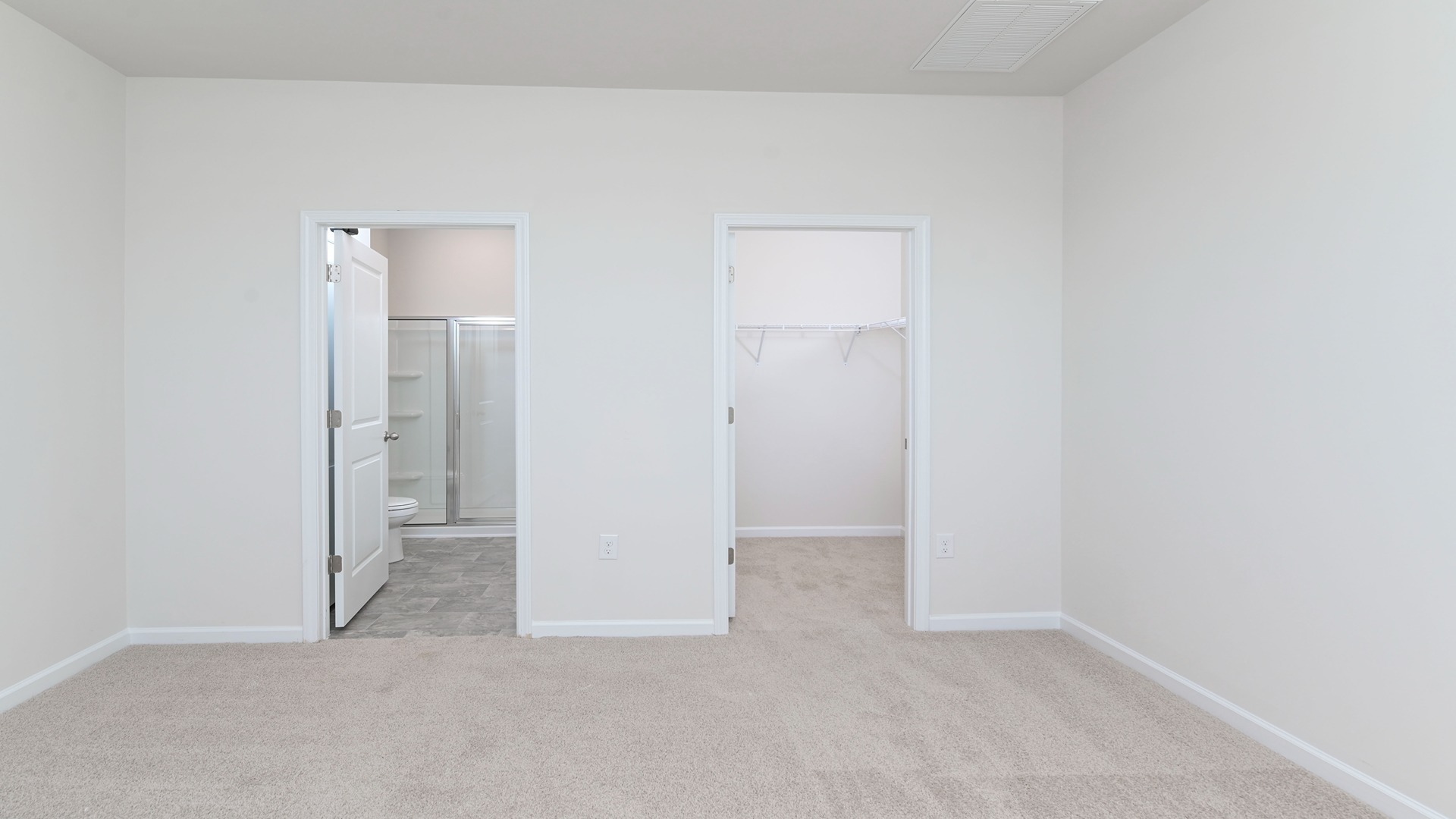 The Primary bedroom is spacious with several windows for natural light.
