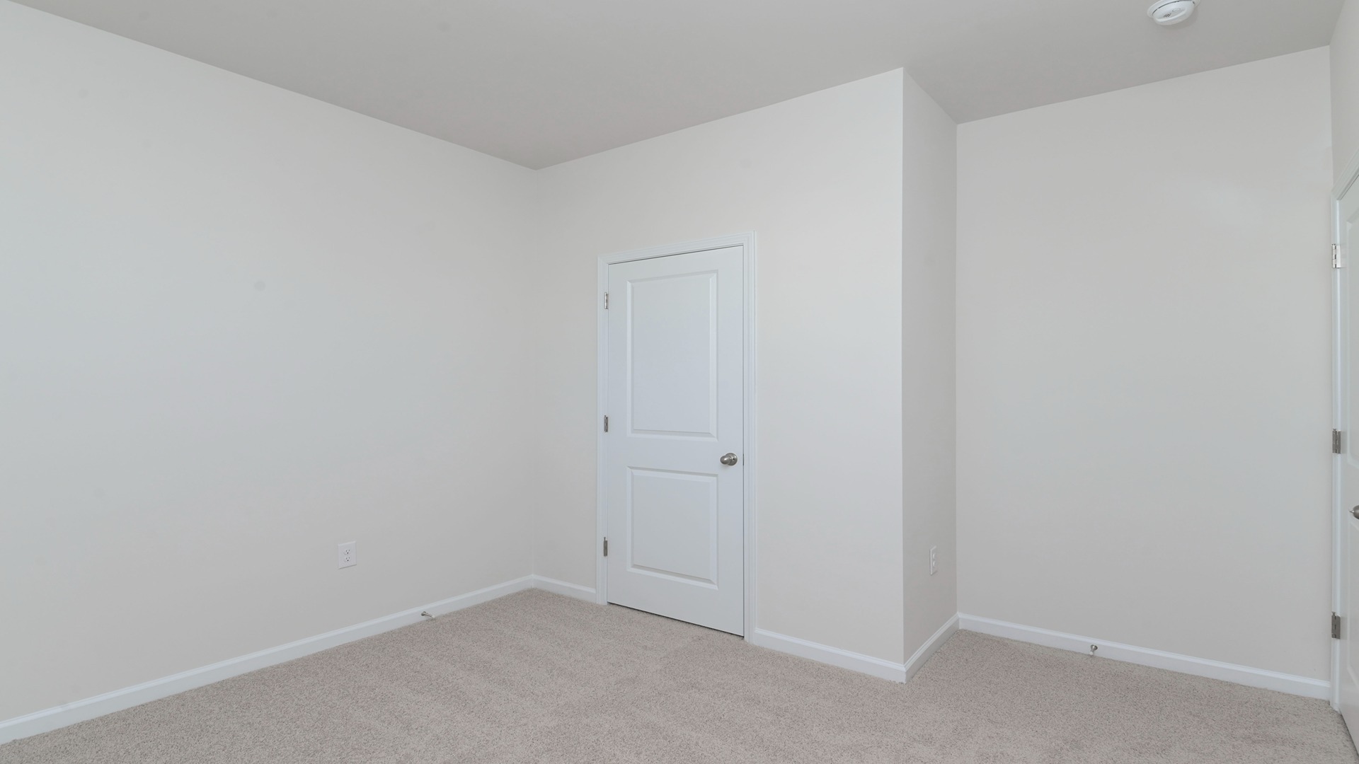 Spacious bedroom with natural light.