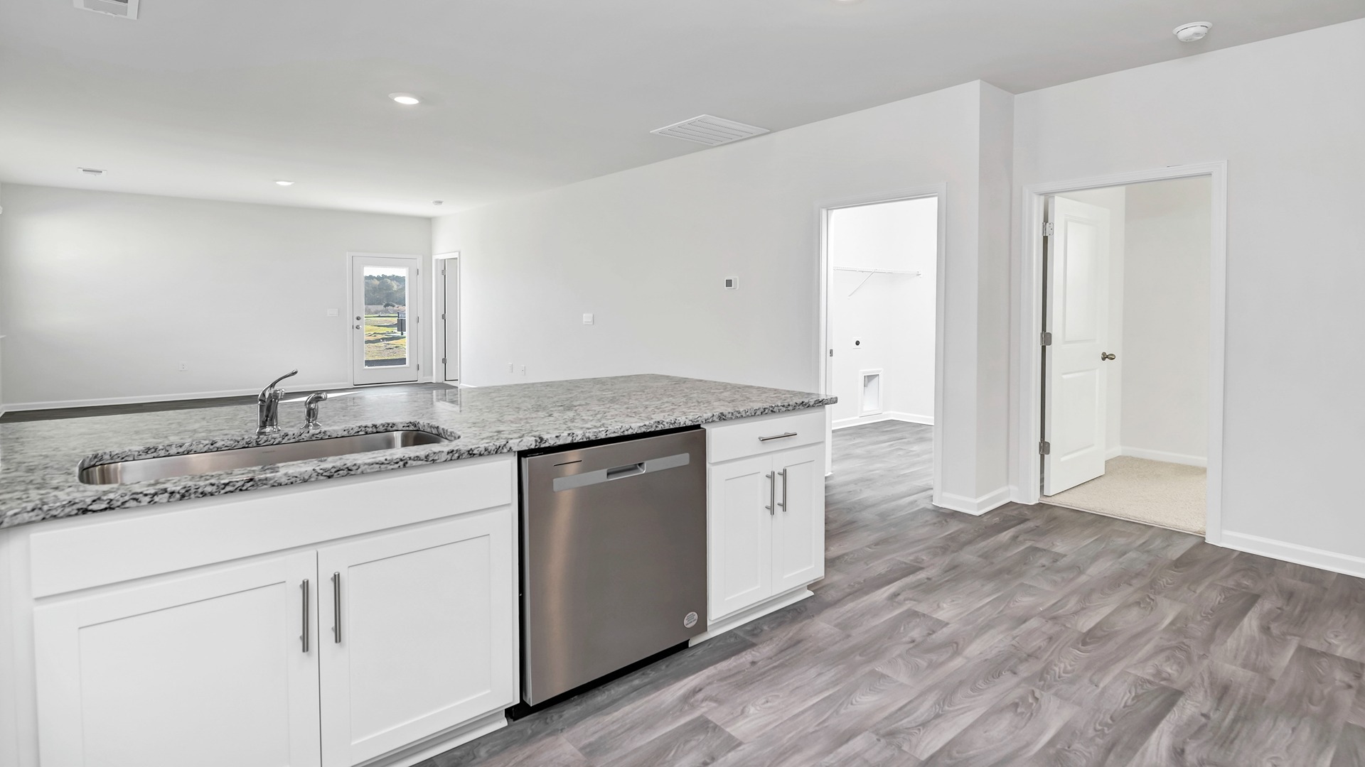 The dining, living, kitchen areas are open concept design finished with Revwood flooring.