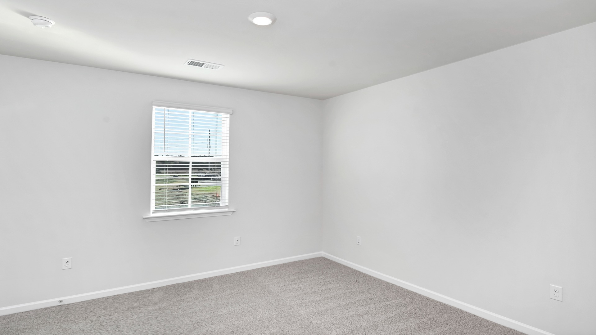 The Primary bedroom is spacious with several windows for natural light.