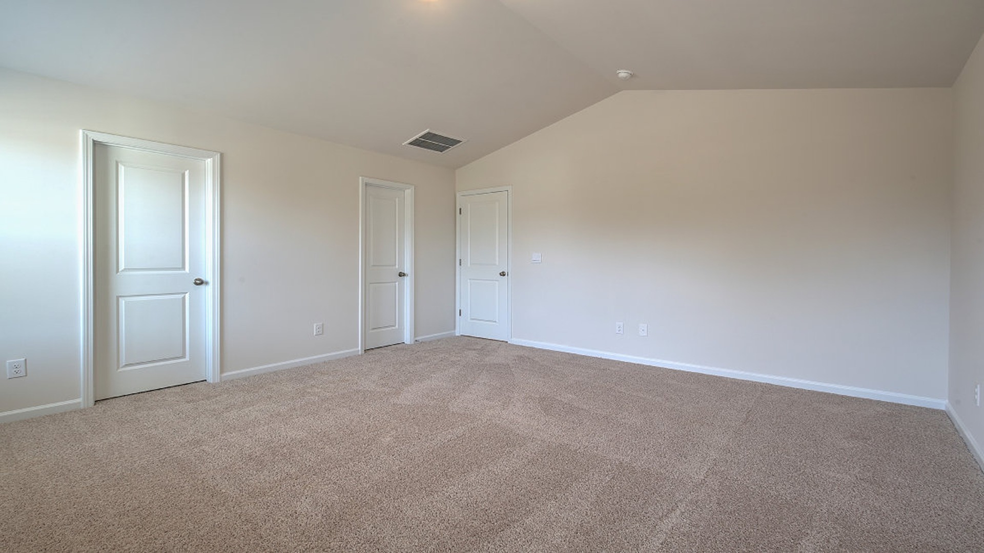 Primary bedroom upstairs with 2 windows and carpet flooring