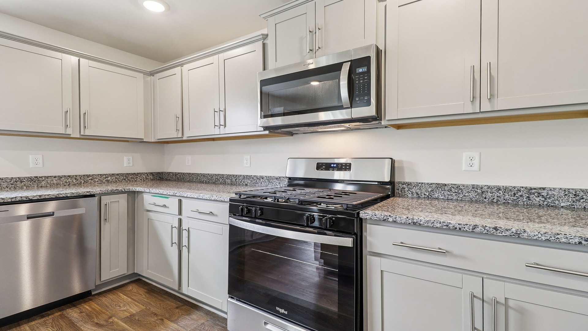 Gray cabinetry and stainless-steel appliances in kitchen