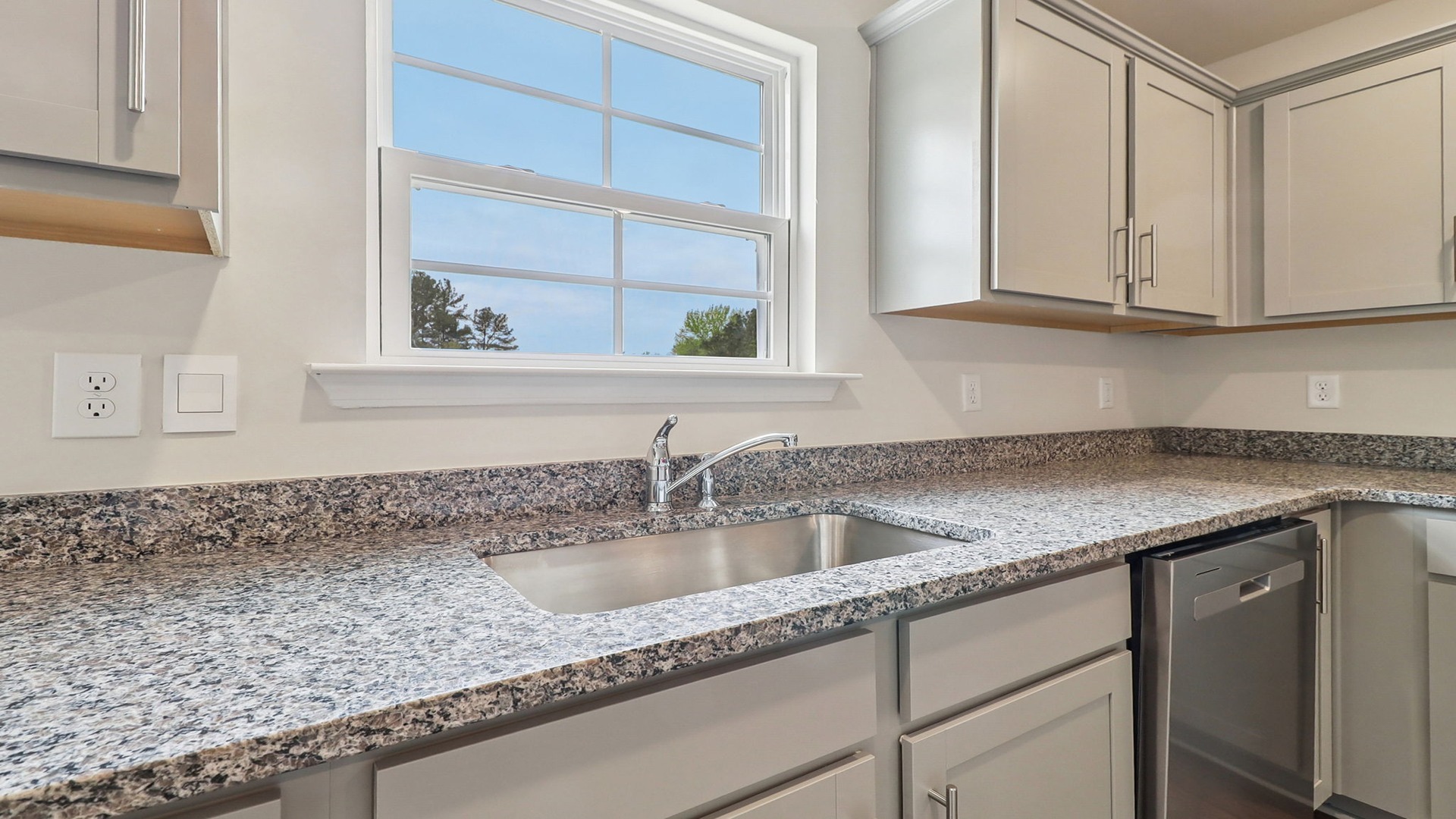 Granite countertops and natural light in the kitchen space