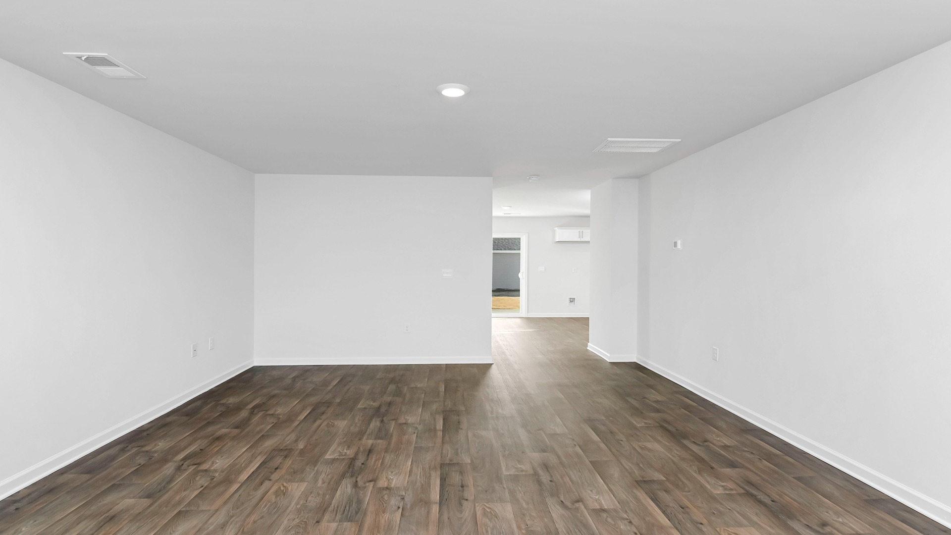 The living area features a window and vinyl flooring