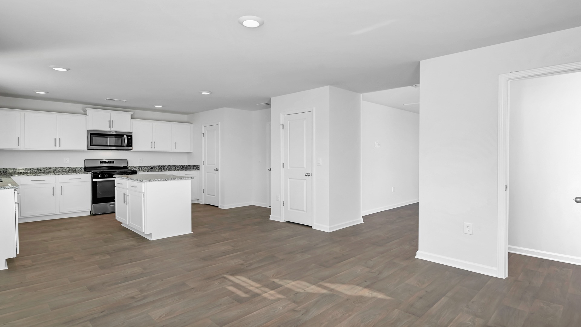 The kitchen and dining areas are open concept with matching vinyl floors