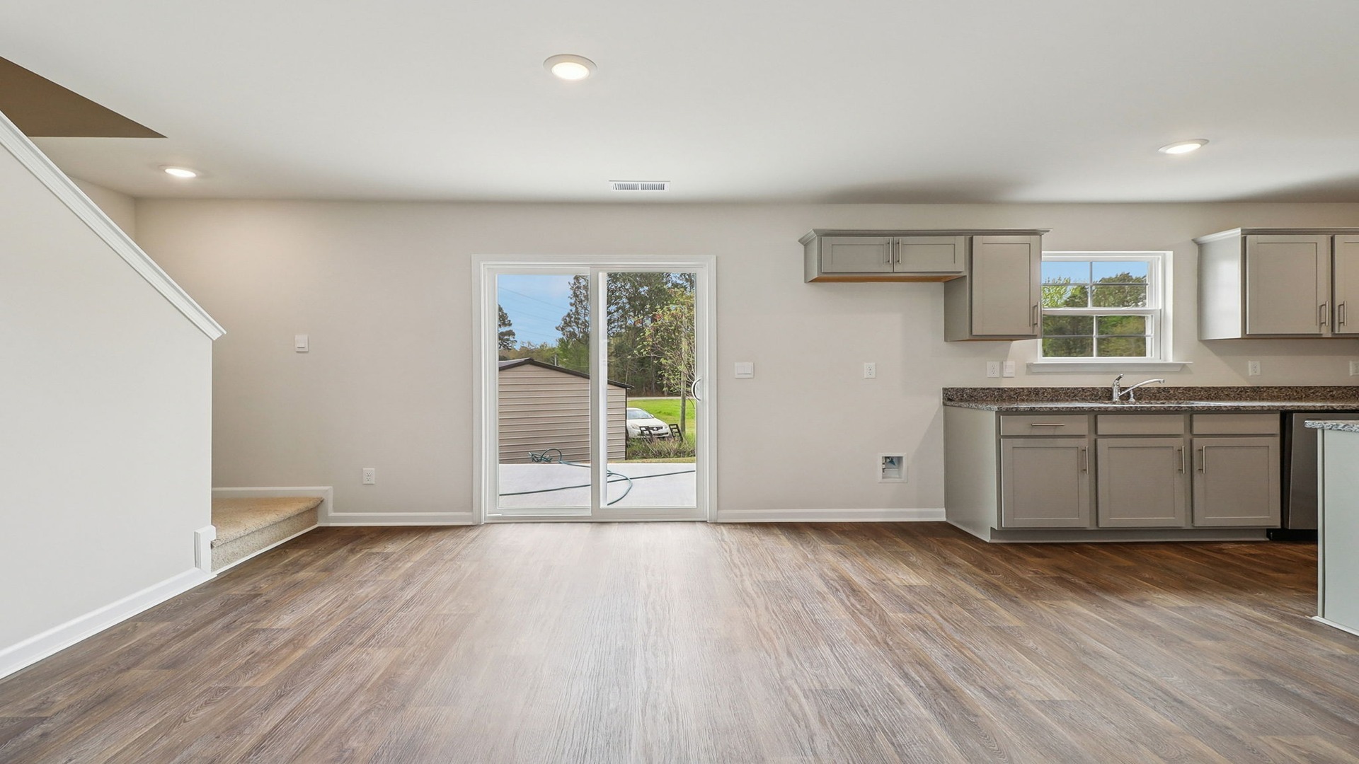 Harrison dining area with vinyl flooring and access to back patio through glass sliding doors