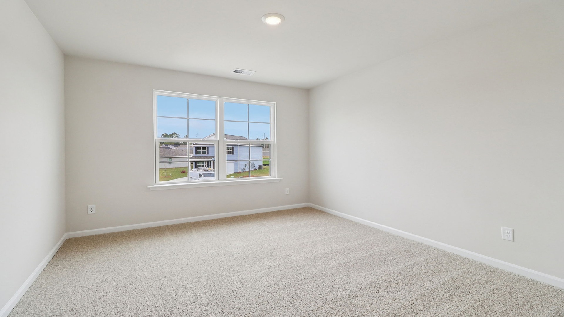 Bedroom 2 with carpet flooring and a large front facing window