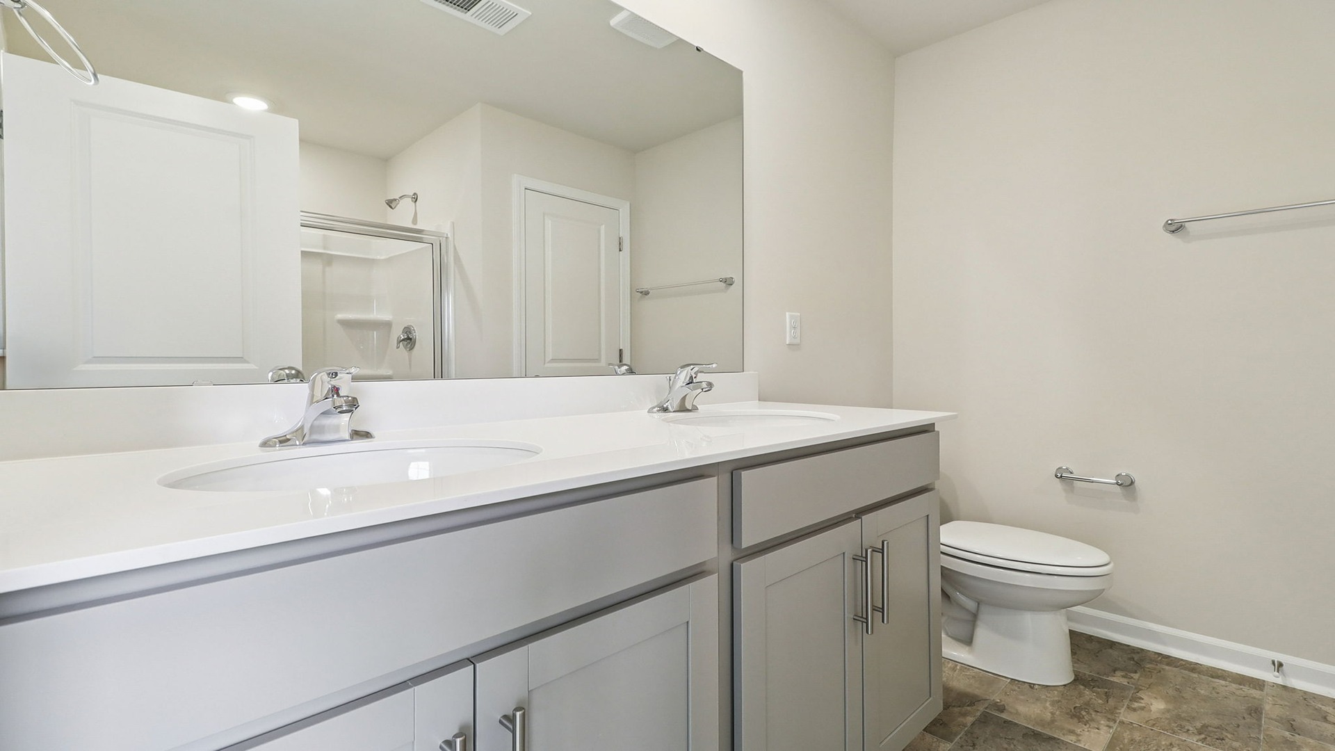 Double primary vanity with gray cabinetry below