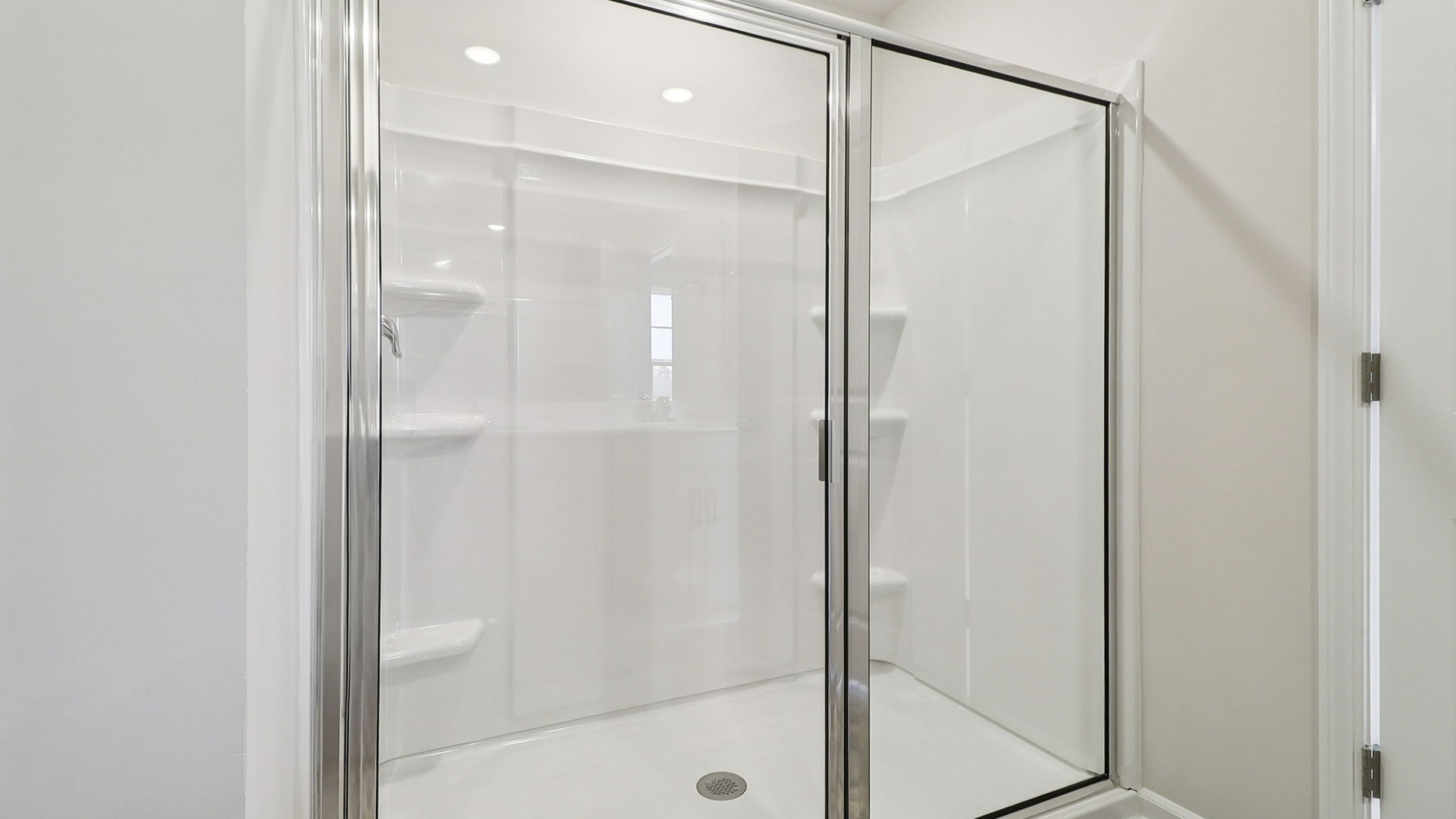 Standup primary shower with glass doors