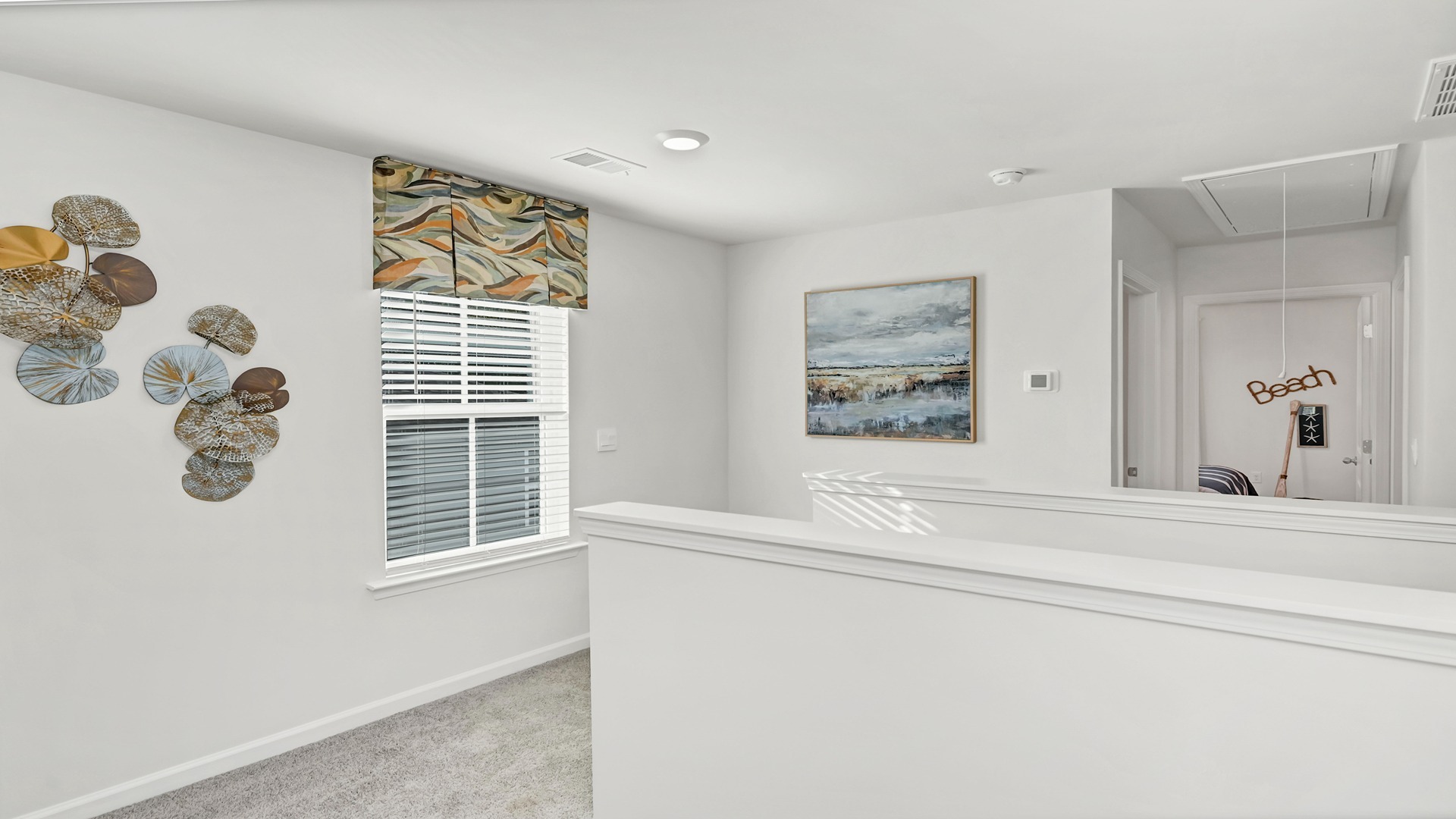 Upstairs stair landing with window and carpet floors