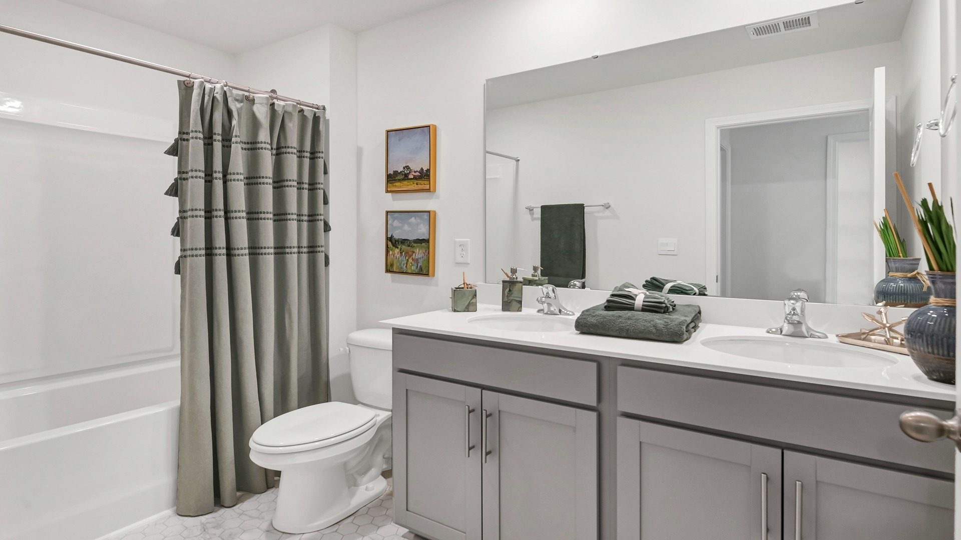 Bathroom 2 upstairs with a shower tub combo and quartz countertops