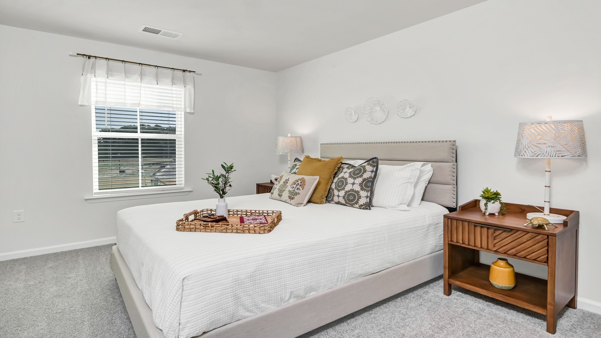 bedroom 2 in the Aisle floorplan upstairs with carpet floors and a window for light