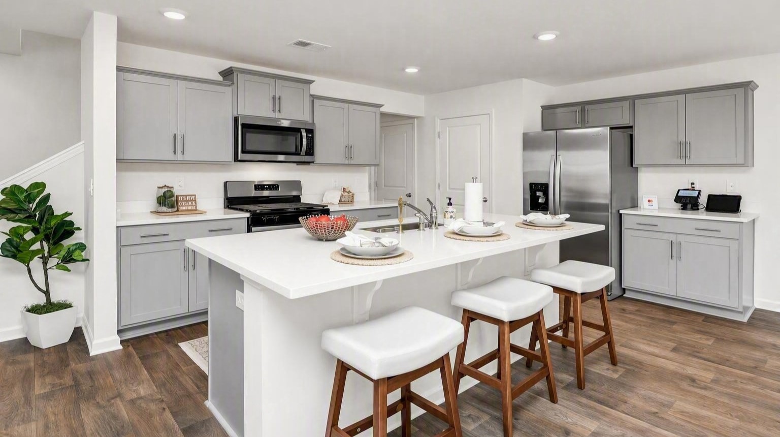 Modern new kitchen with white quartz countertops and gray cabinetry