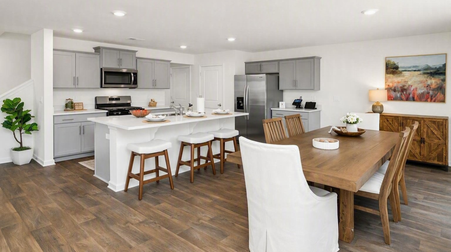 Completely open-concept kitchen and dining area with matching vinyl floors in new home for sale in Orangeburg, SC