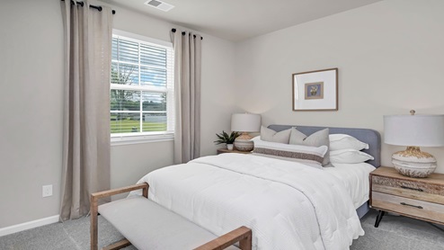 Bedrooms 2 and 3 are towards the front of the home and feature private closets, carpet flooring, and windows.