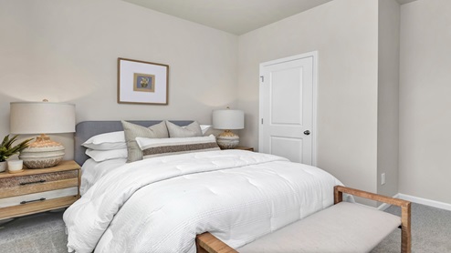 Bedrooms 2 and 3 are towards the front of the home and feature private closets, carpet flooring, and windows.