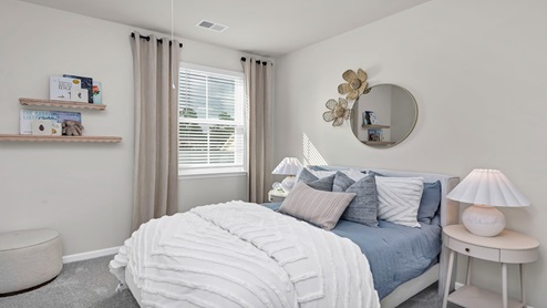 Bedrooms 2 and 3 are towards the front of the home and feature private closets, carpet flooring, and windows.