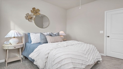 Bedrooms 2 and 3 are towards the front of the home and feature private closets, carpet flooring, and windows.
