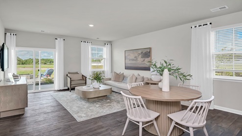 The dining and living areas are open concept and finished with vinyl flooring.