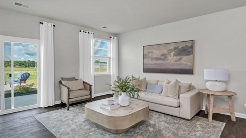 The living area is spacious with several large windows.