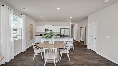 The kitchen and dining area are open concept and offer plenty of seating options.