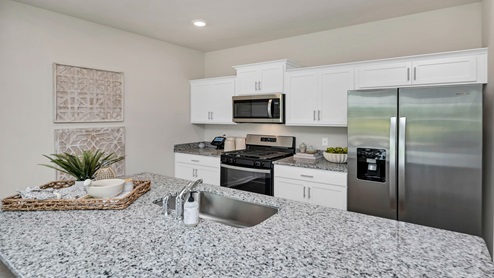 Modern granite countertops finish the kitchen space.