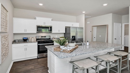 There are white shaker-style cabinets in this Devon kitchen.