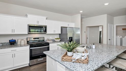 There are white shaker-style cabinets in this Devon kitchen.
